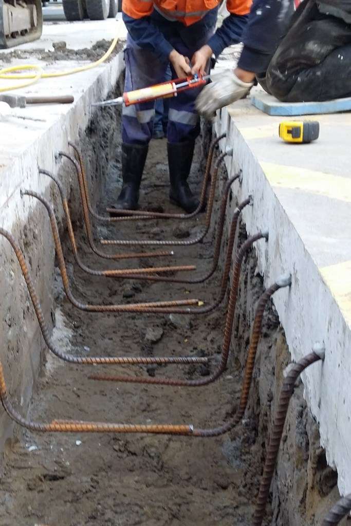 Rebar is inserted into the holes and cemented with expoxy resin